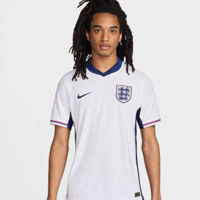 A man wearing the official England football jersey