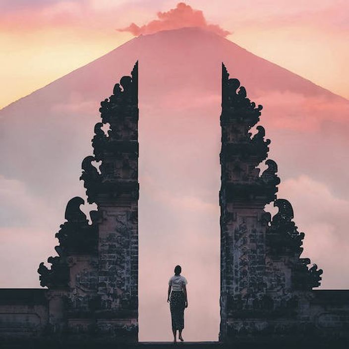 Person between  Candi Bentar gates in Indonesia