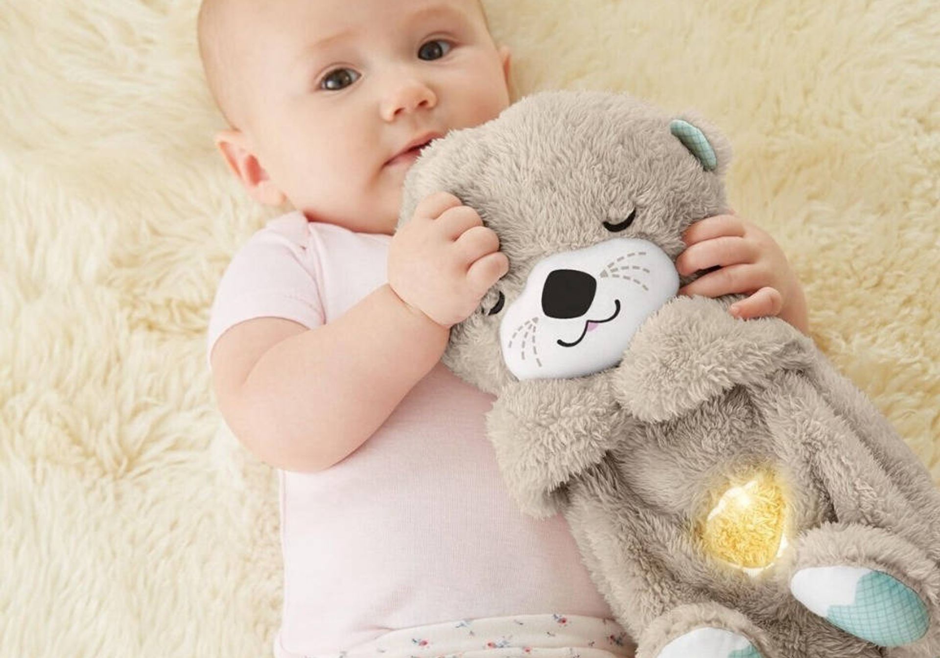 Fisher-Price Soothe 'n Snuggle Otter cuddled by baby
