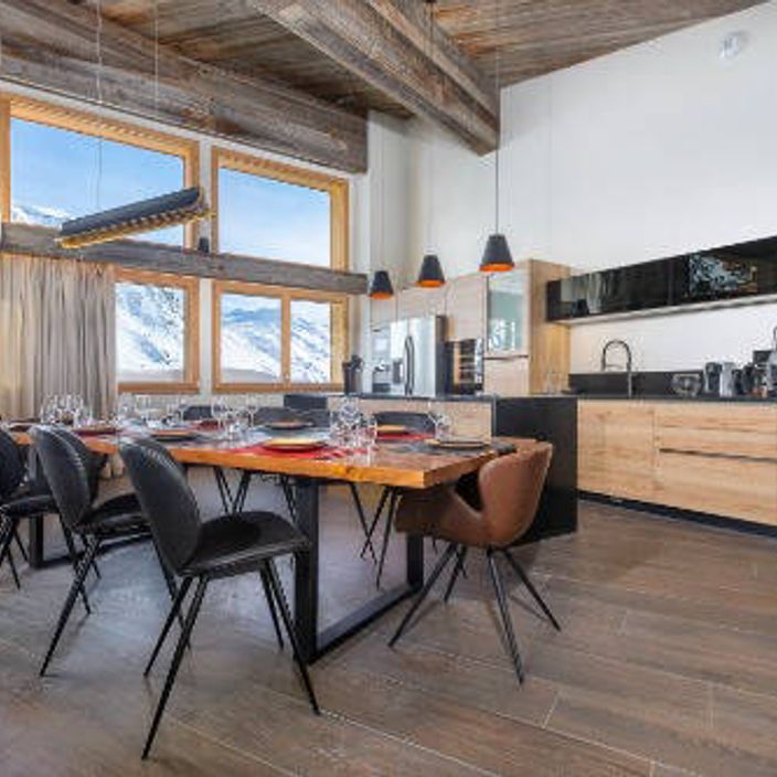 a kitchen and dining table in a skiing chalet
