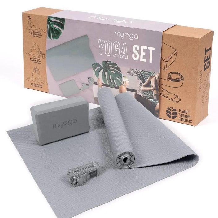 Lady doing yoga on grey mat