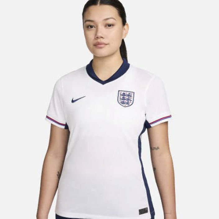 A woman wearing the official England football jersey