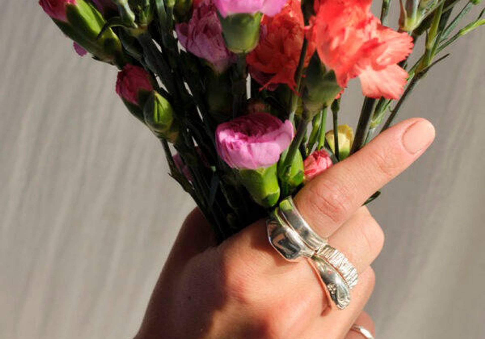 multiple Workbench Silver rings modelled on hands with flowers