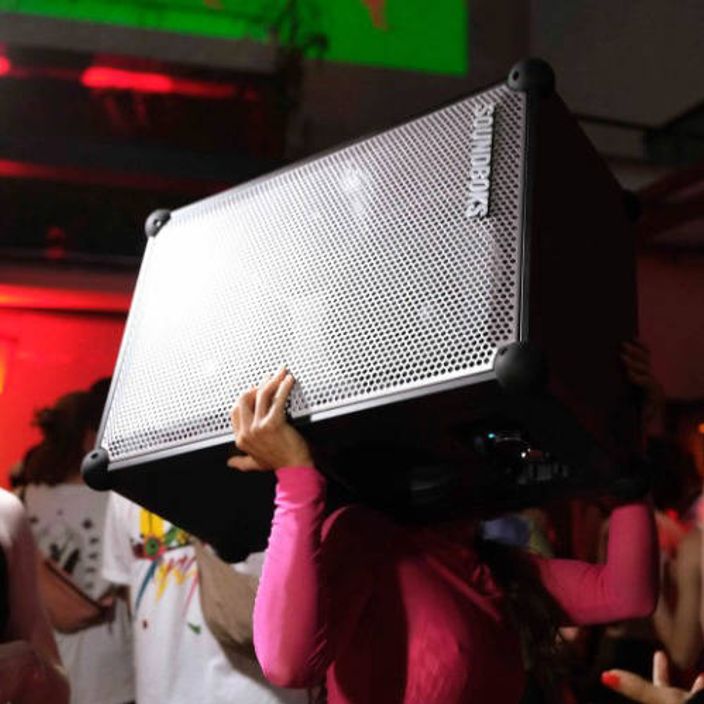 A person holding a Soundboks 4 in their arms