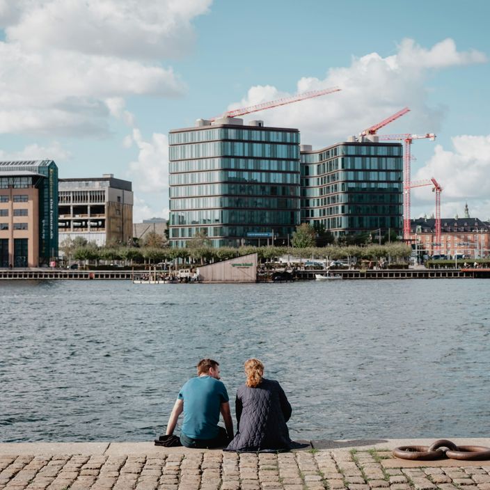 A couple sitting by the water in Copenhagen