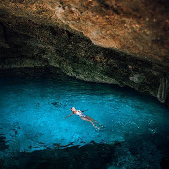 Woman swimming in freshwater lagoon
