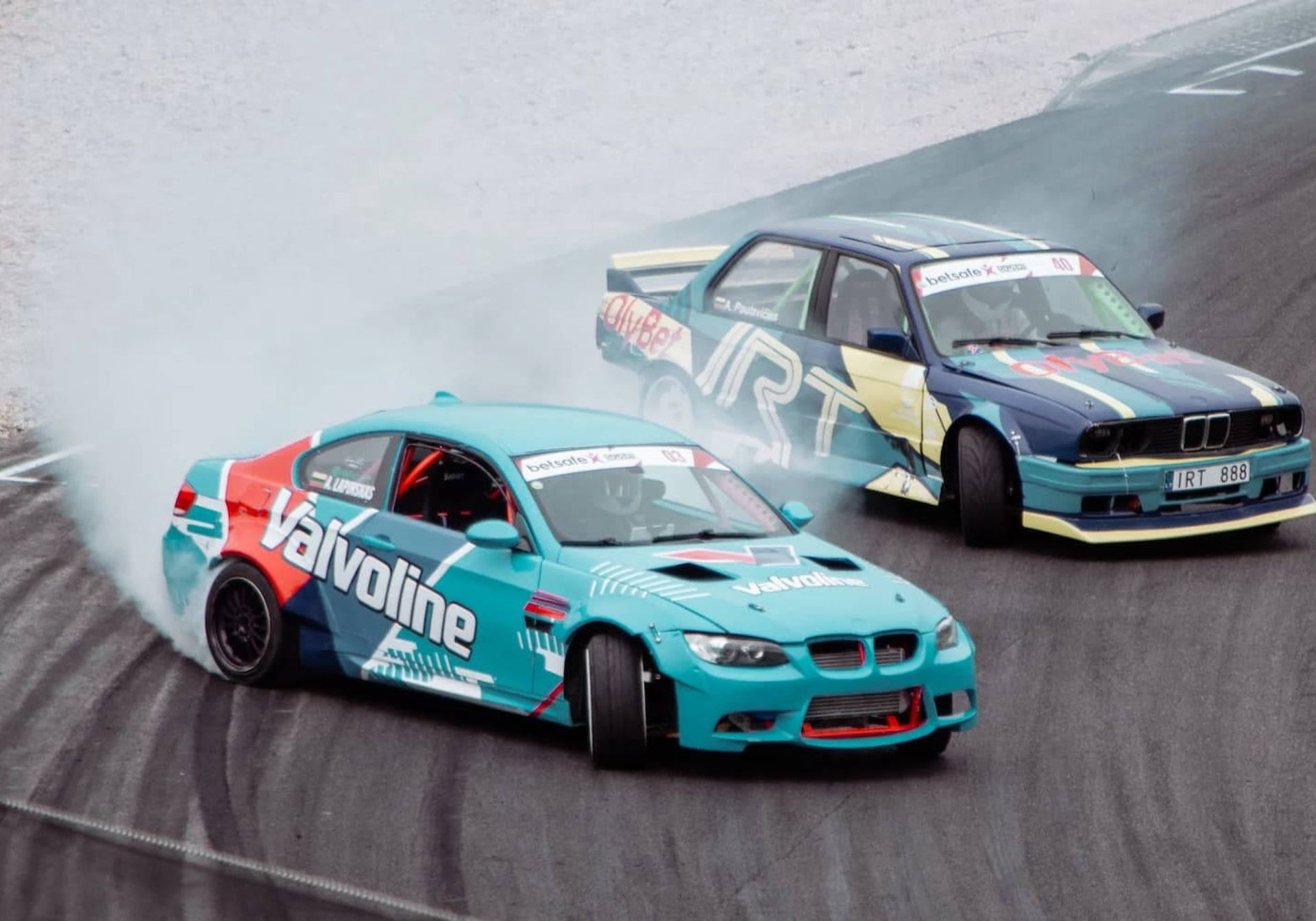 two cars drifting on a race track