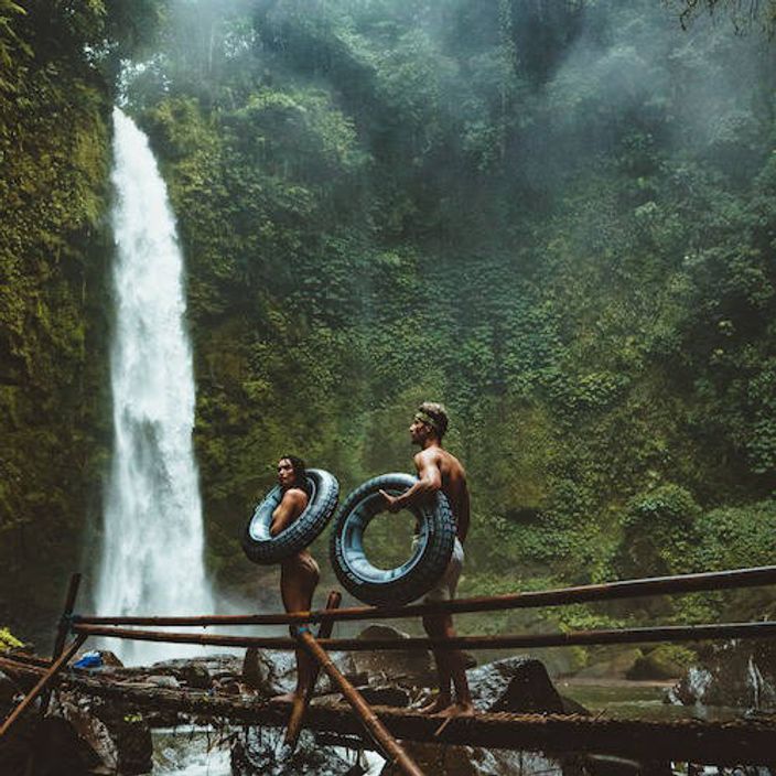 Couple exploring a waterfall