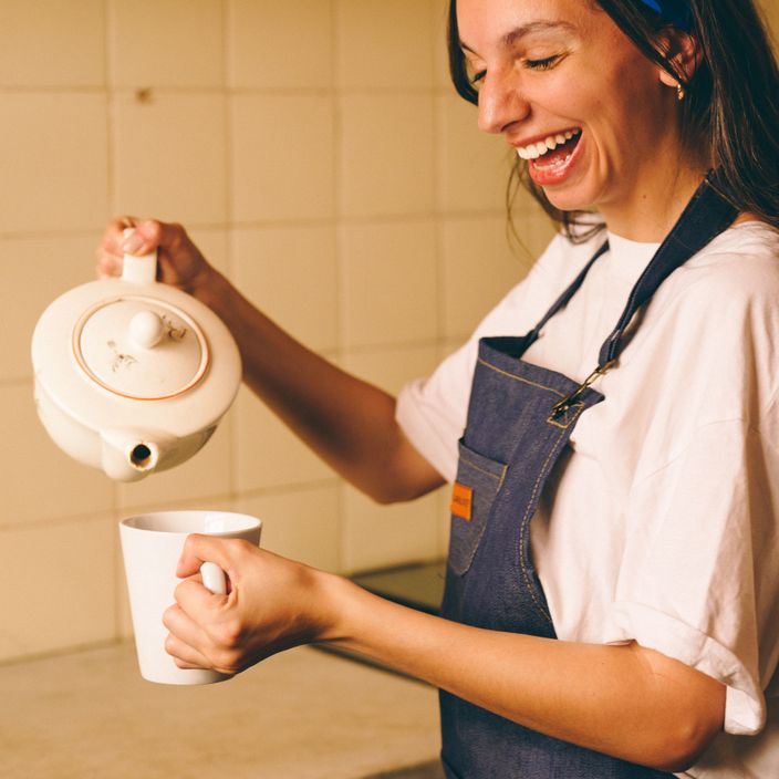 A girl pouring the kettle for a tea 