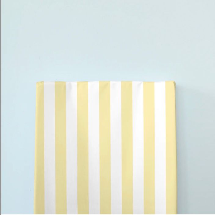 The little bumble co. anti roll changing mat yellow stripe blue background