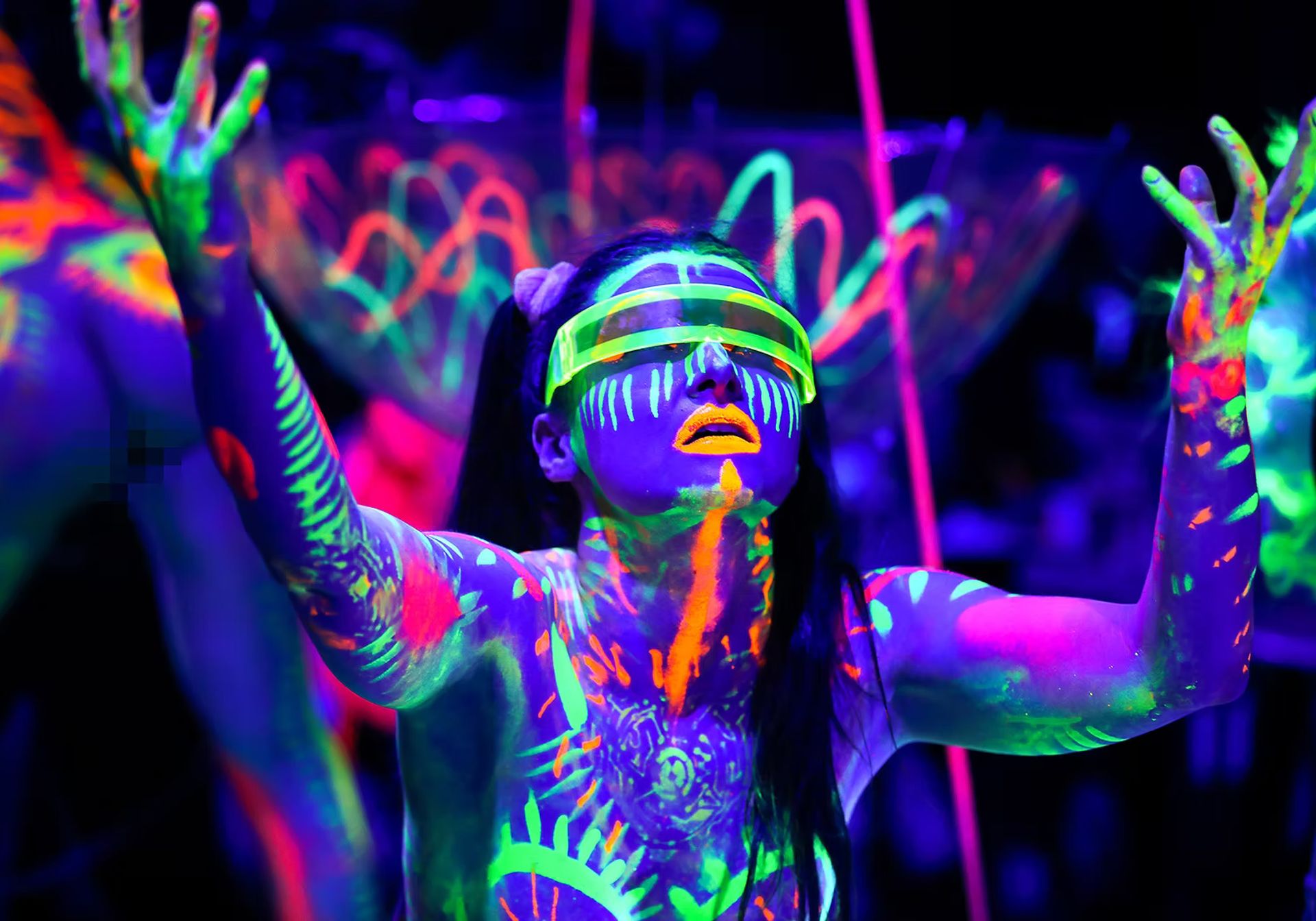 Woman covered in neon paint