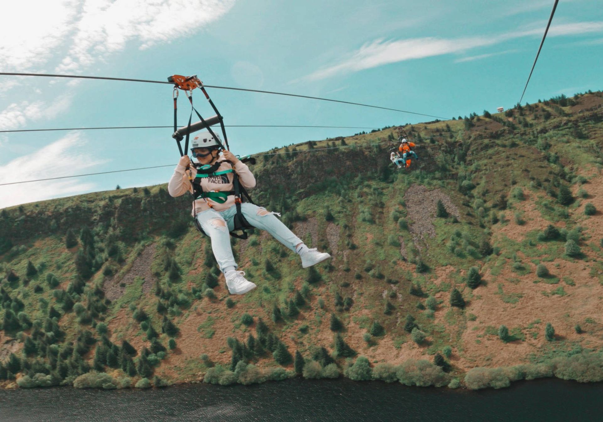 Woman zip lining in Wales