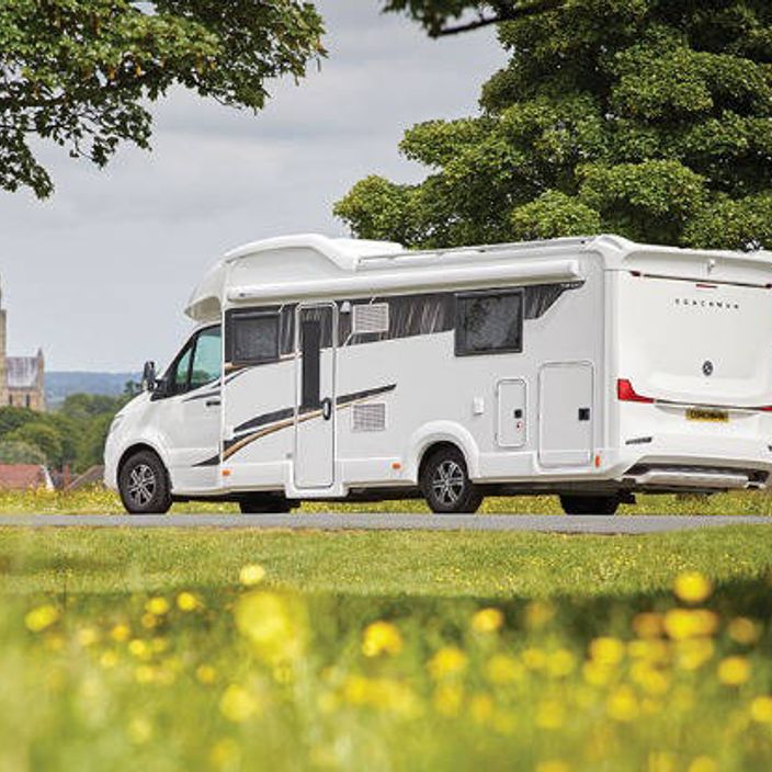 Coachman motorhome parked in a field