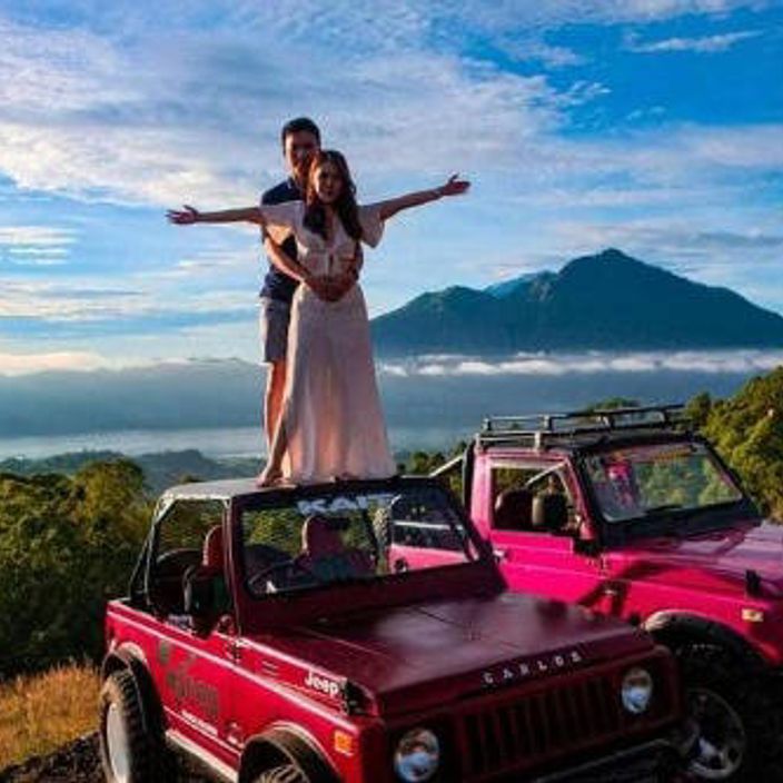 couple standing on jeep at mount batur tour
