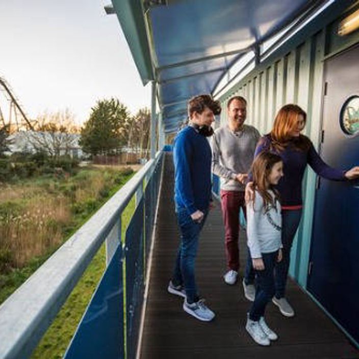 family in front of shark cabin in Thorpe Park