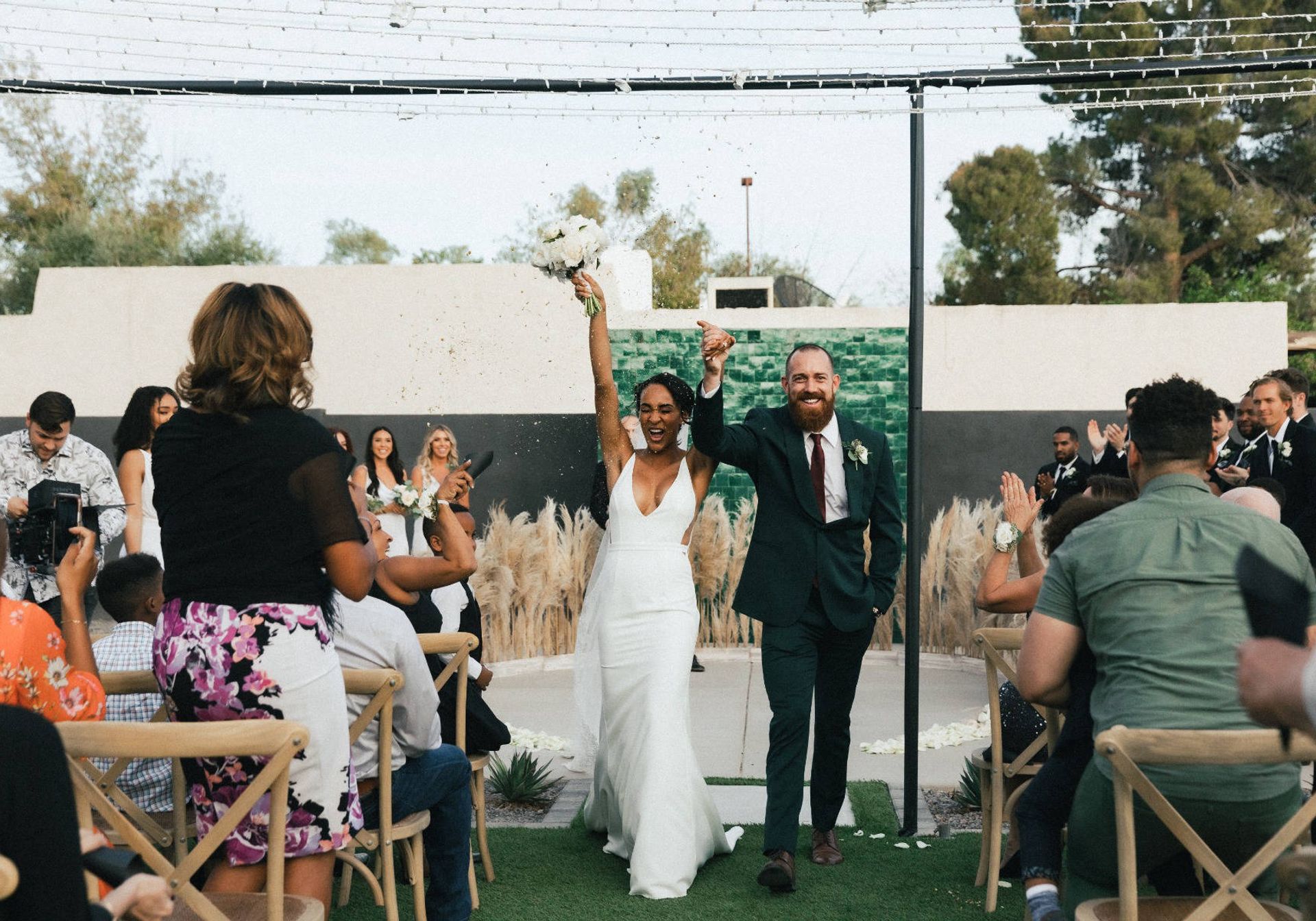 man and woman happy walking down the isle