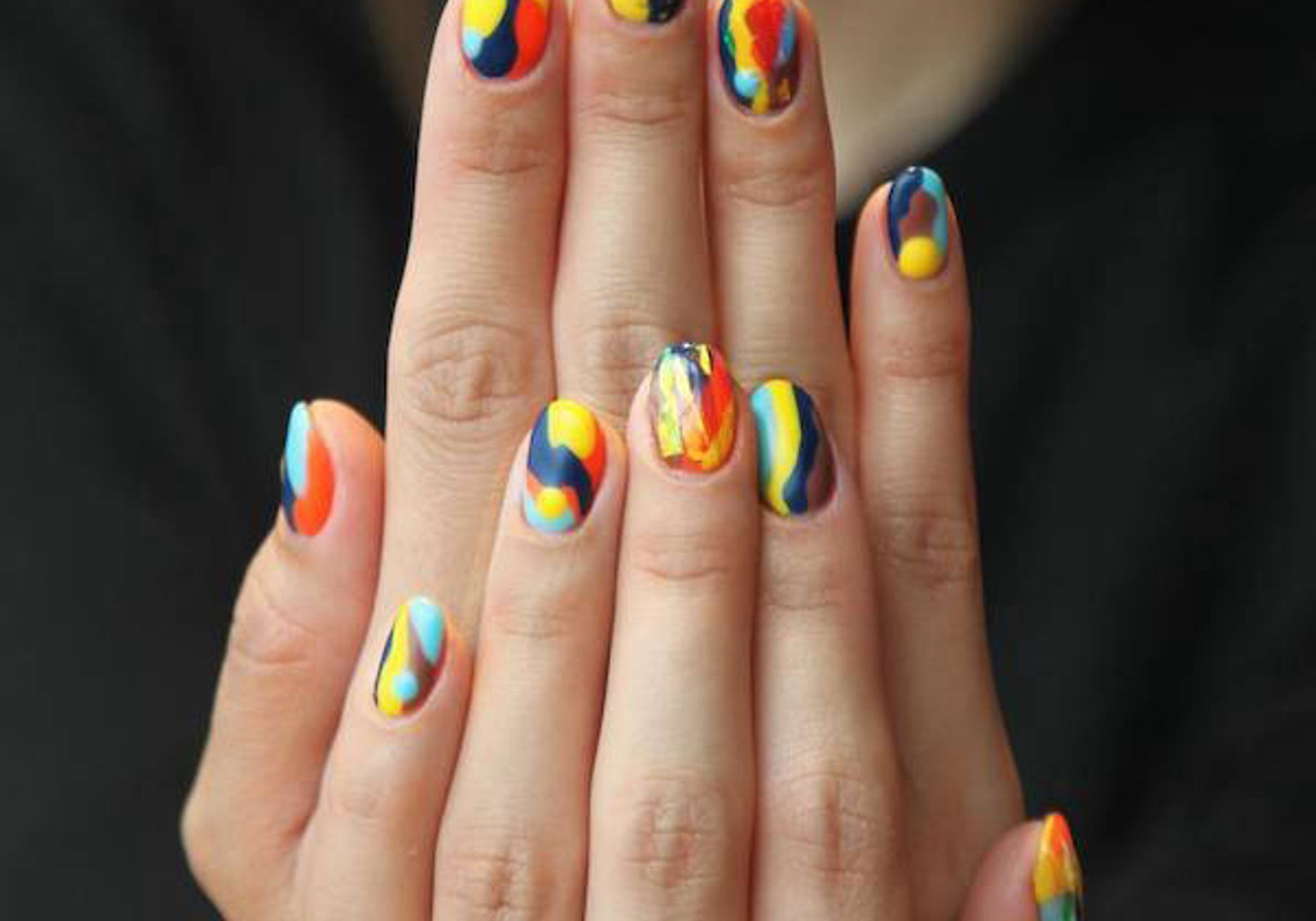 Hands with colourfully-painted nails