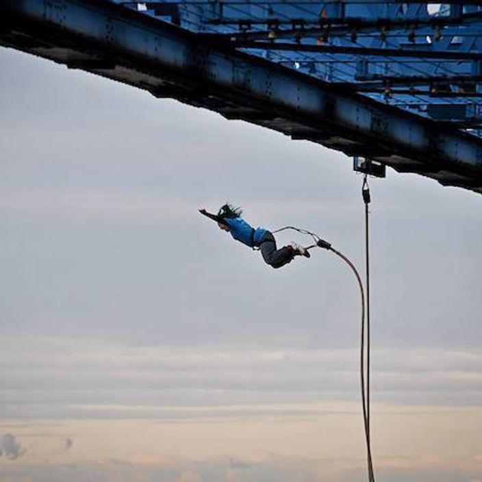 Person bungee jumping off platform