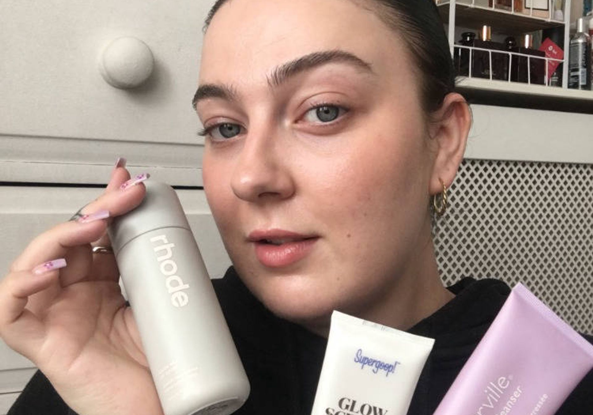 Megan displaying her favourite skincare items
