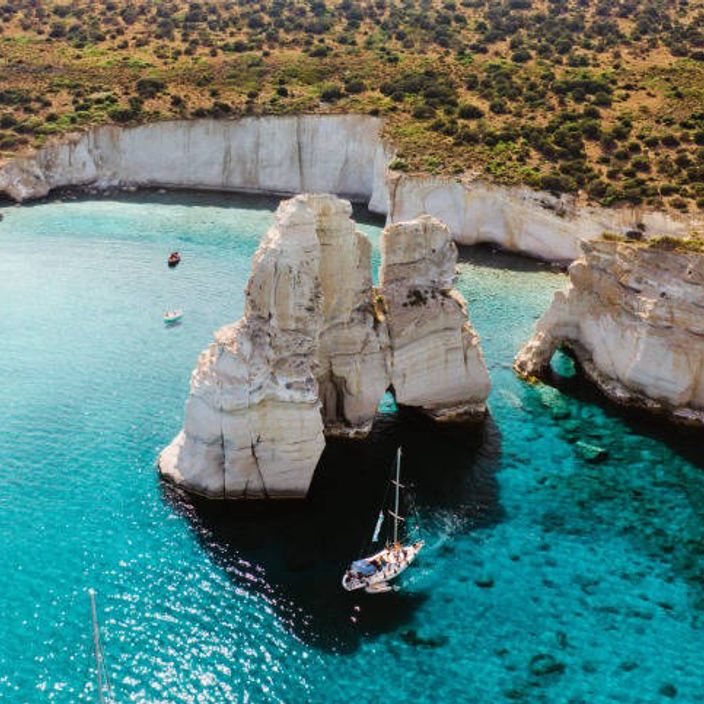 a picture of a boat tour through milos