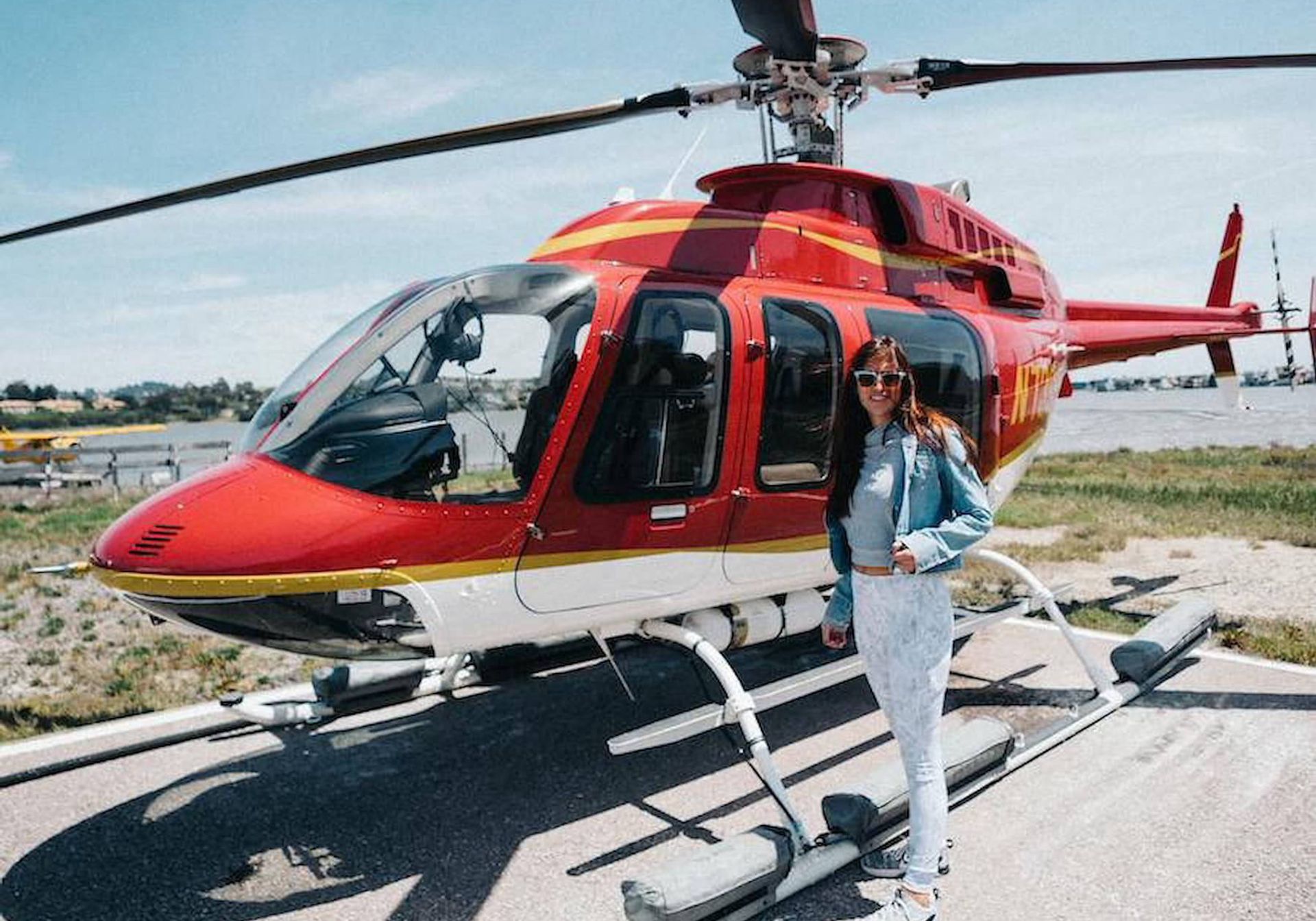 A women stood outside a helicopter
