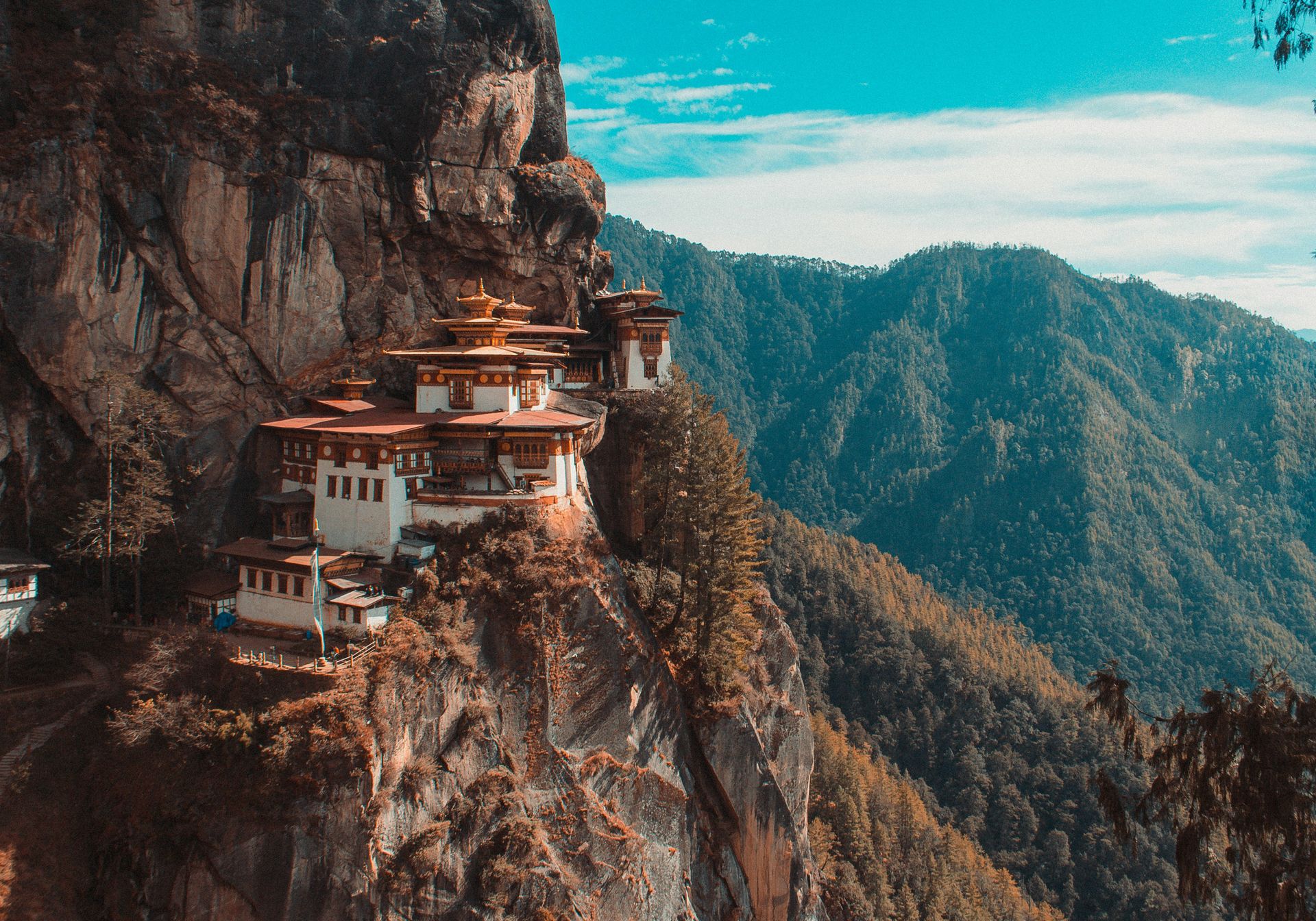 Woman sitting looking at incredible views over Bhutan mountains
