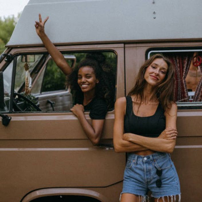 Two women with a brown VW Campervan