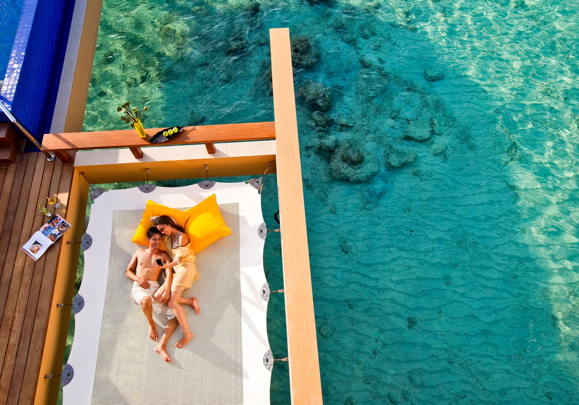Couple lying on a bed over the sea
