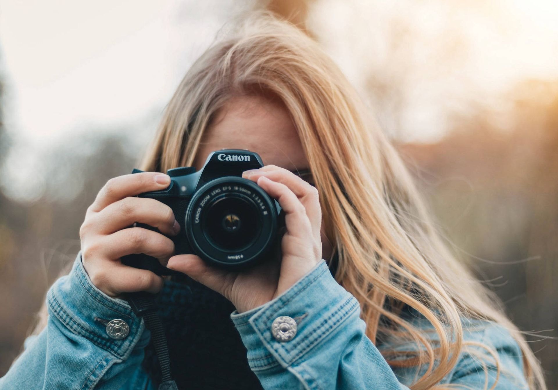 Woman holding Canon DSLR camera