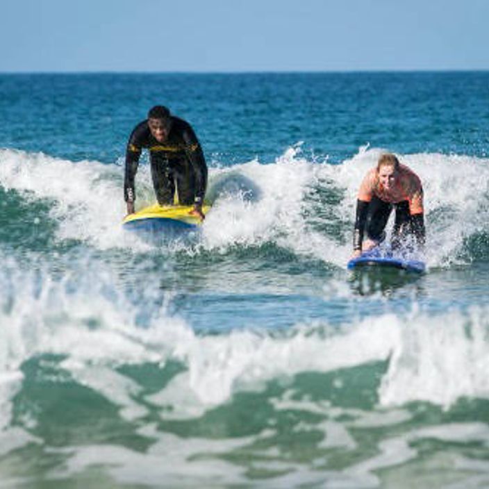people surfing in cornwall