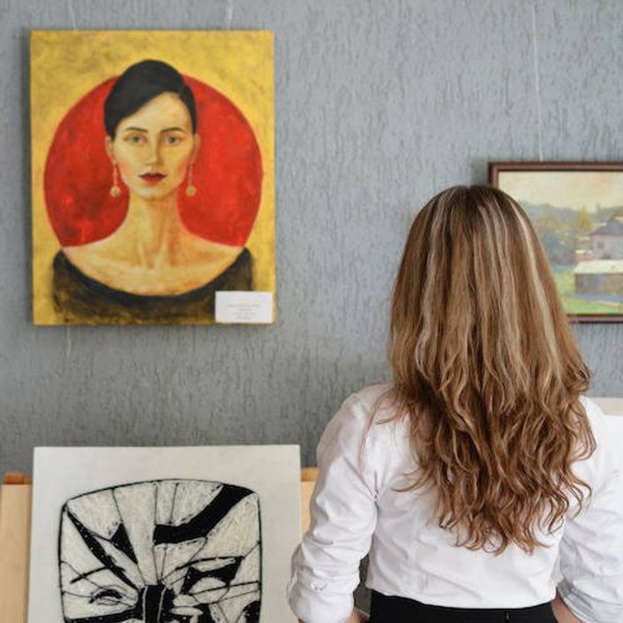 Woman viewing art in a gallery