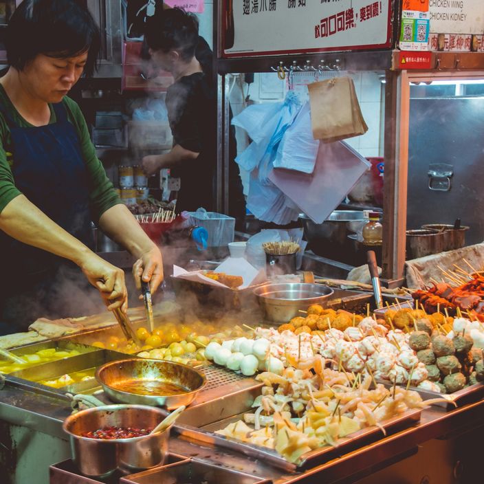Couple walking through a street food market