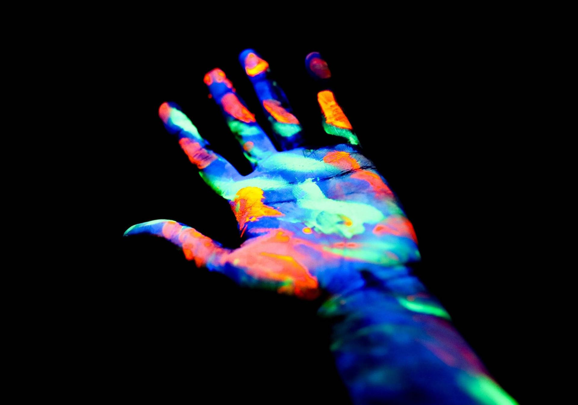 A hand in neon paint 