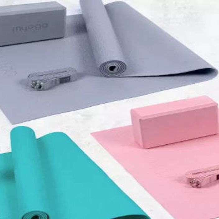 Lady doing yoga on grey mat