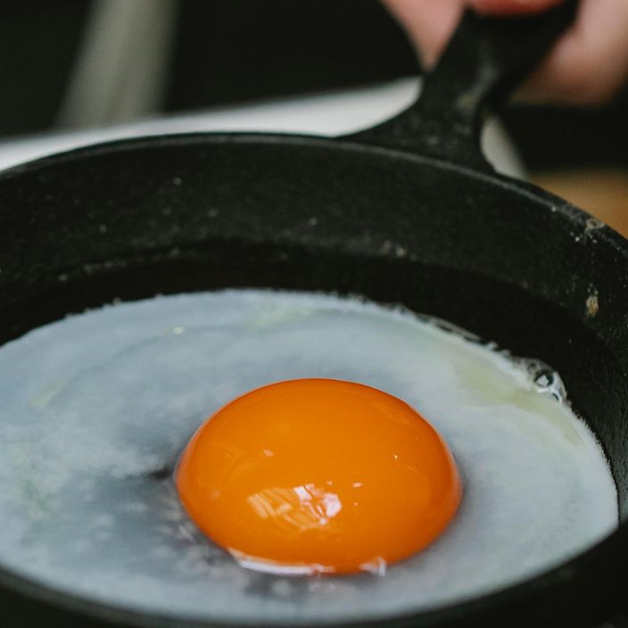 a blue sea salt ourplace pan with a spatula in it