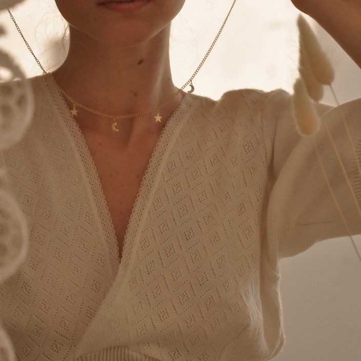 woman wears a necklace