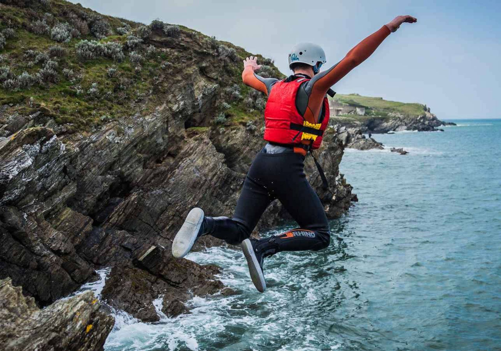 man surfing in cornwall blue water