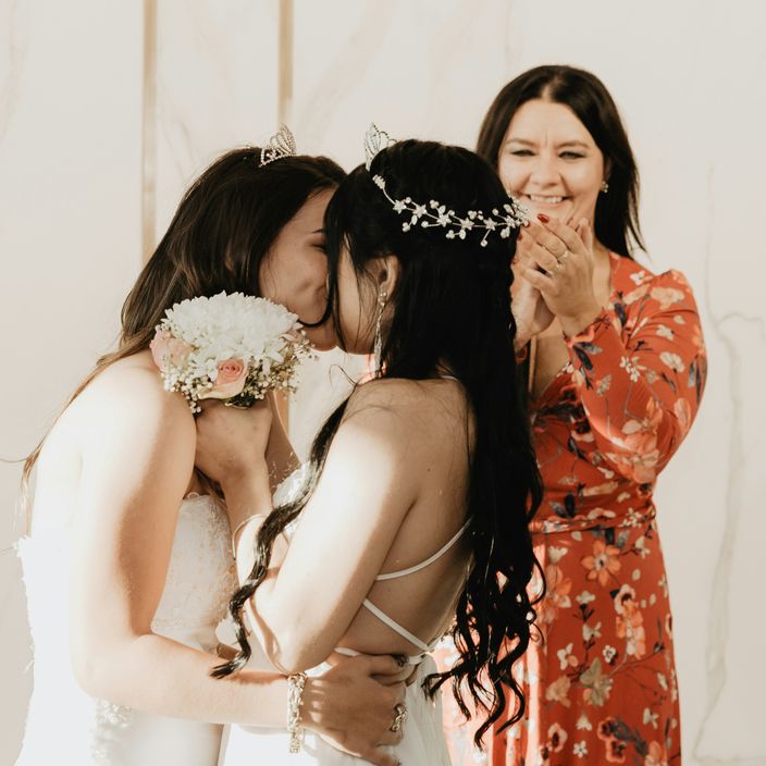 a man and a woman laughing who just got married