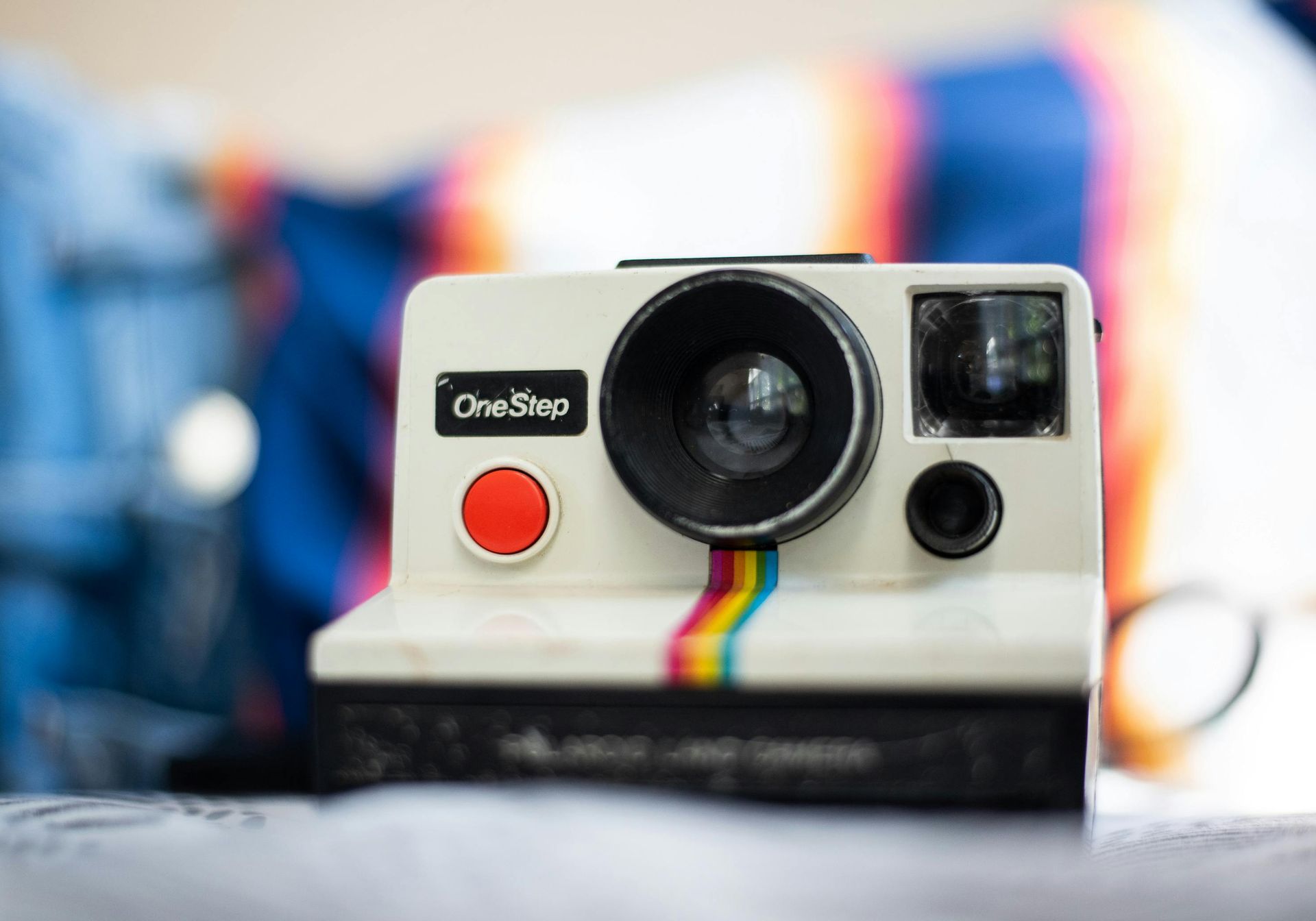 A women taking a photo with a Polaroid camera