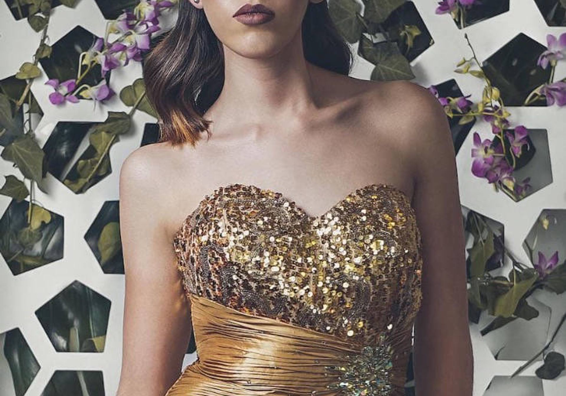 Woman in a golden dress with floral background