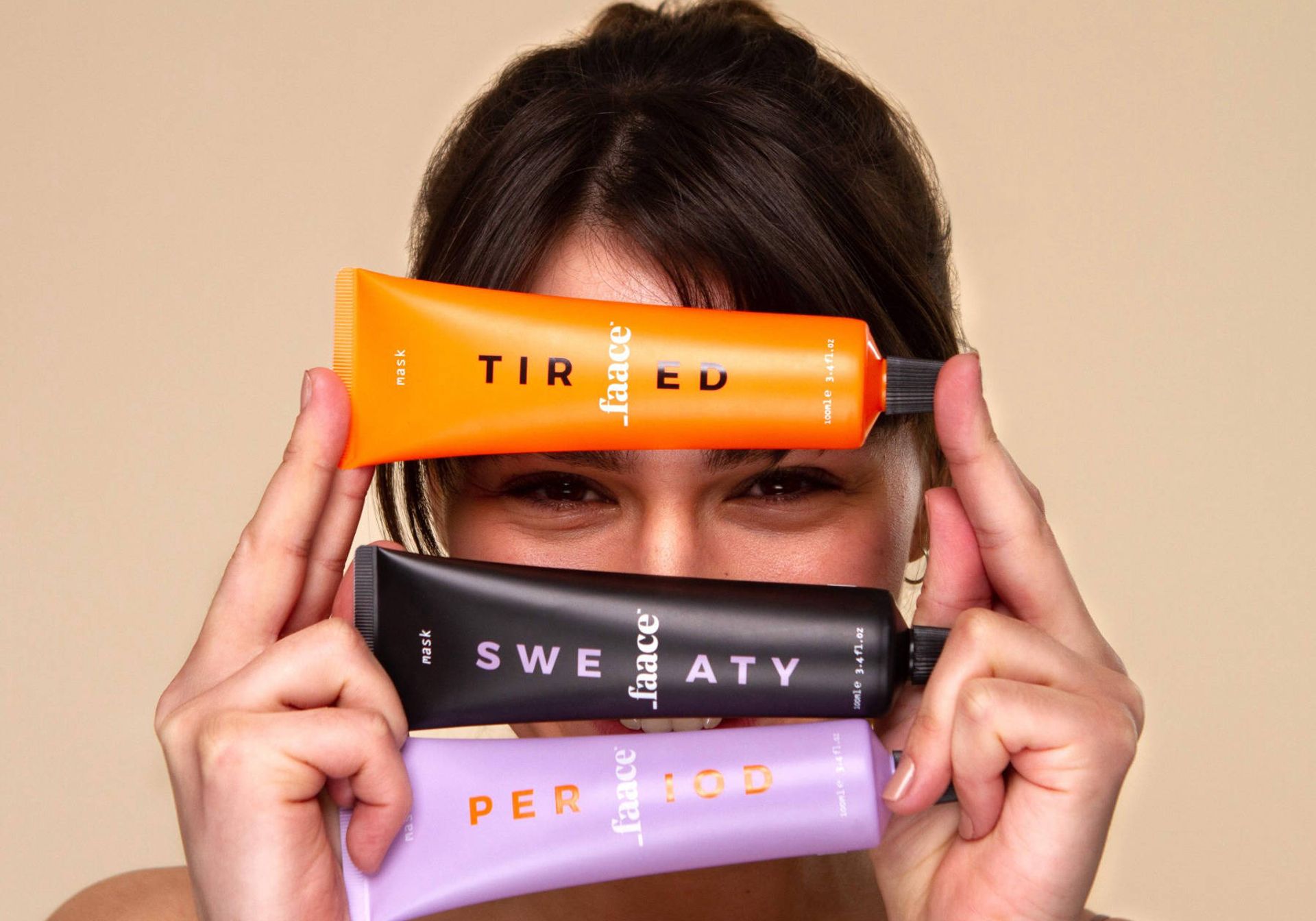 A girl holding 3 bottles of _Faace skincare