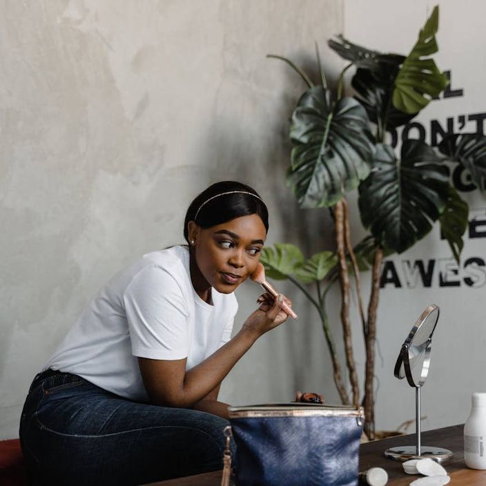 Two friends putting on make up