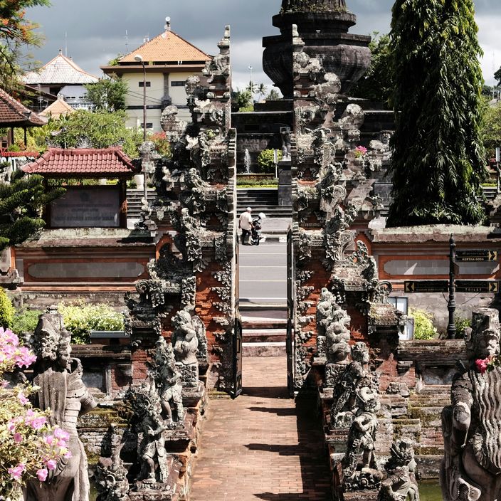 Person between Candi Bentar gates in Indonesia