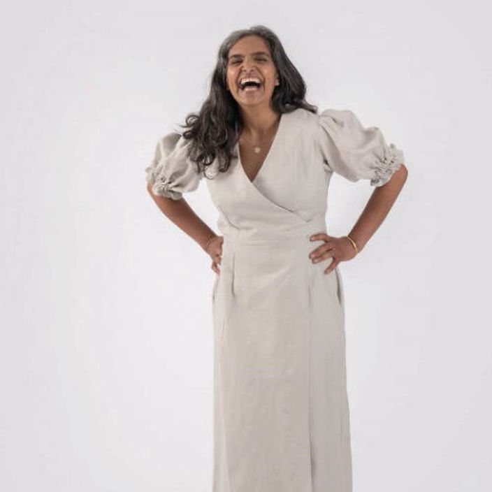 Woman laughing wearing white dress