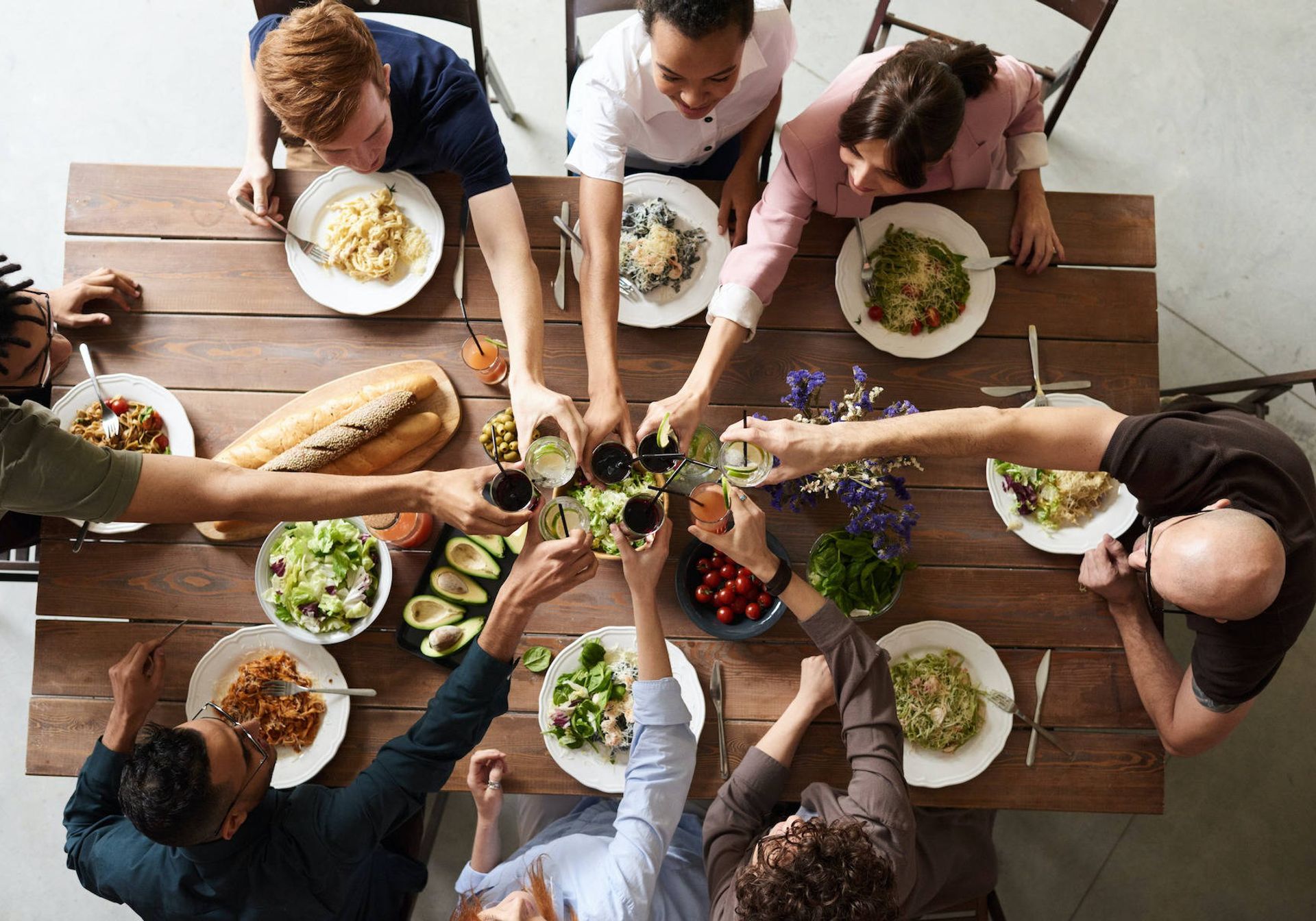 Friends eating and drinking around a table