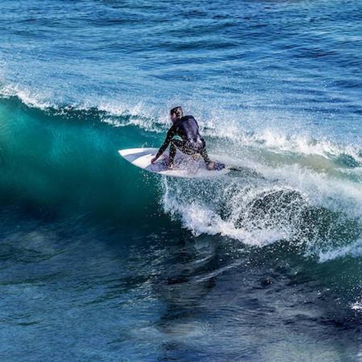 Surfer on the top of a wave