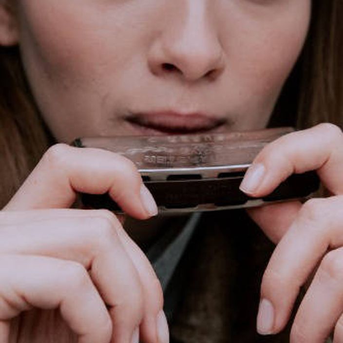 Woman playing the harmonica