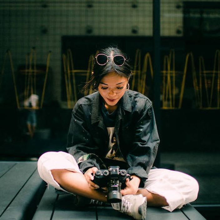 Woman holding camera in her lap