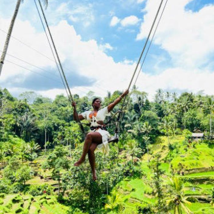 a black woman on a swing in Bali