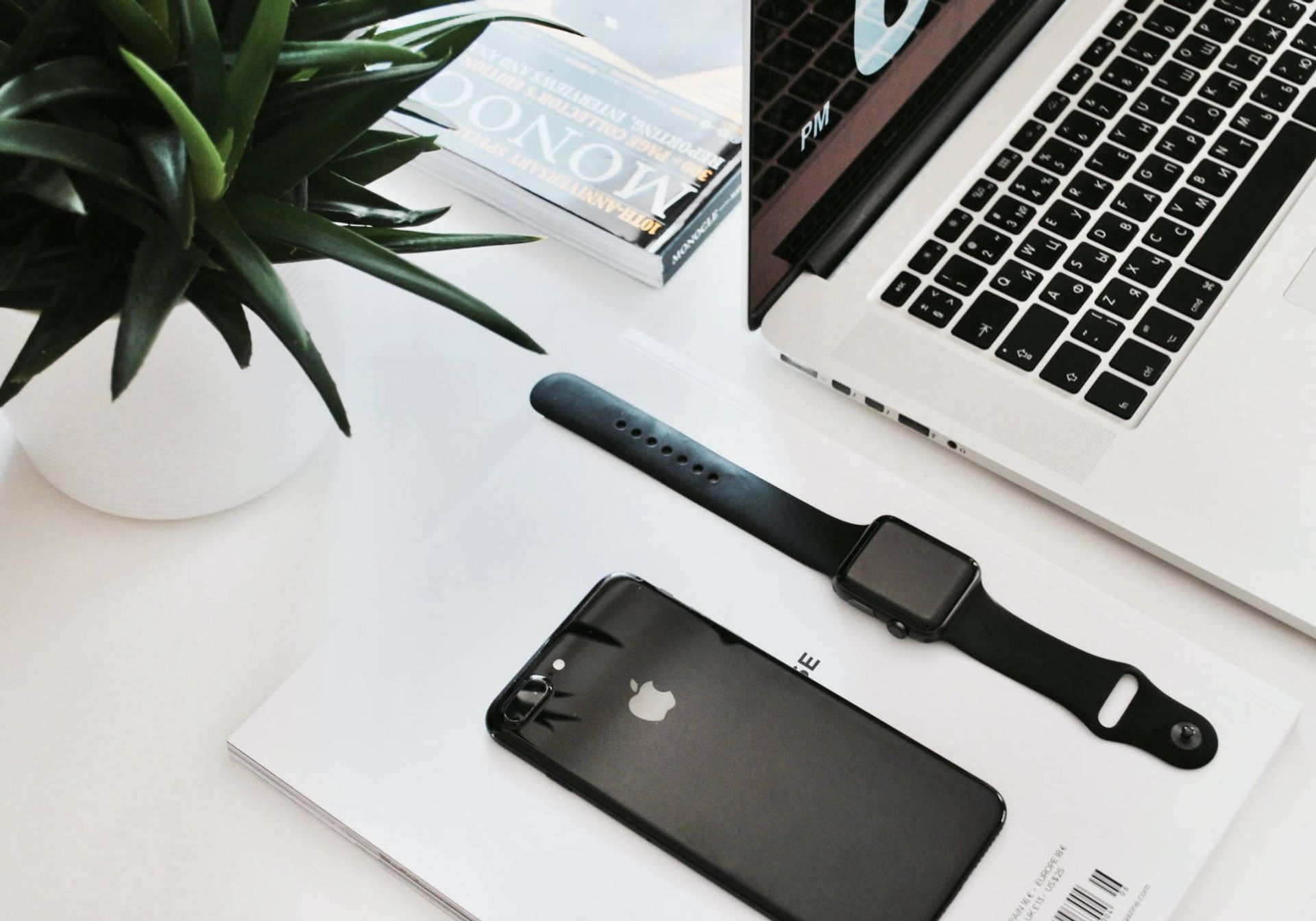 Home office desk with iPhone apple watch and Macbook pro